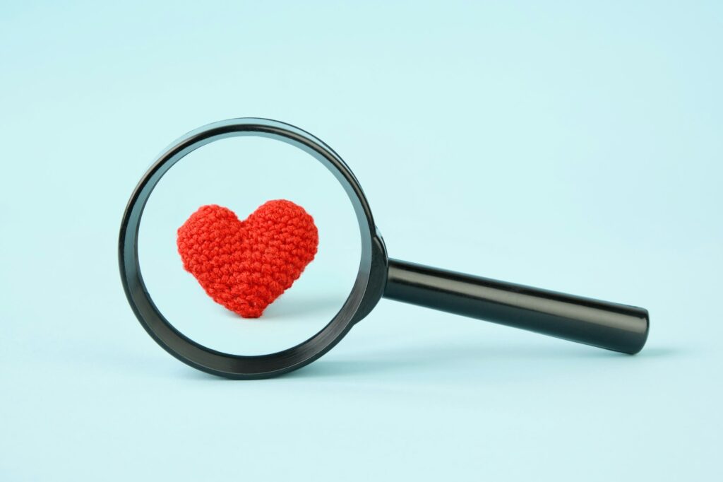 Heart under a magnifying glass. Love, heart examination concept.