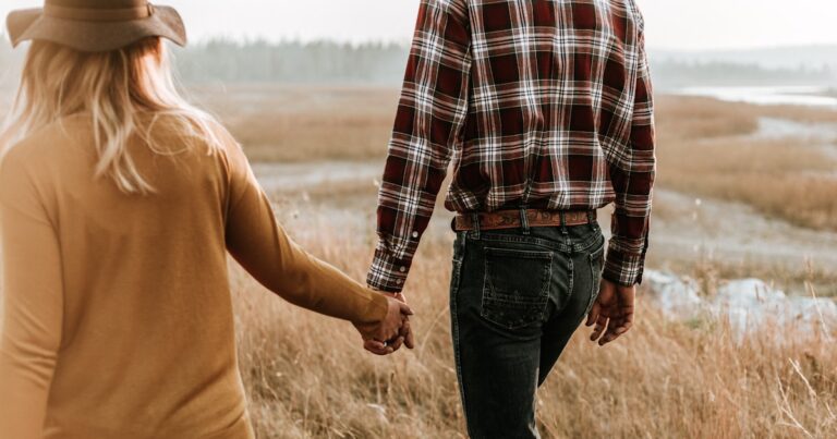 Home 68 A couple walking holding hands, on attachment styles in dating