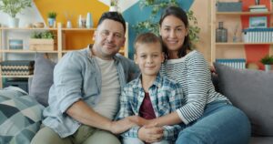 Blog 34 Parents and child on a couch, illustrating parenting as a team