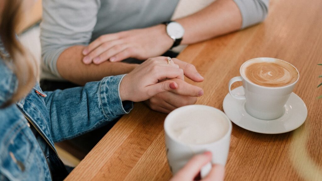 A couple holding hands on a date, the kind of slow-building connection the spark myth overlooks